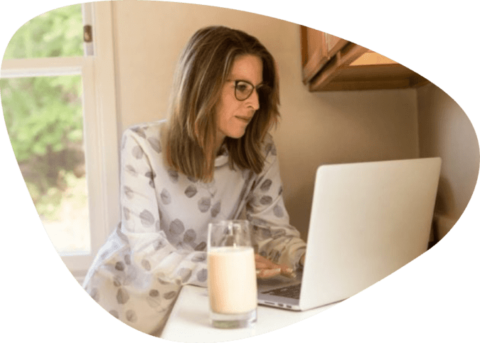 Woman using gray laptop computer in kitchen 1251833 1 675x450@2x