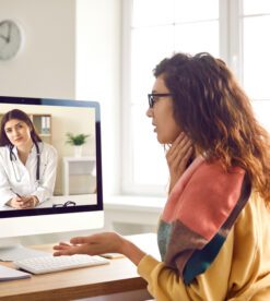Woman with sore throat having medical consultation with online doctor via video call
